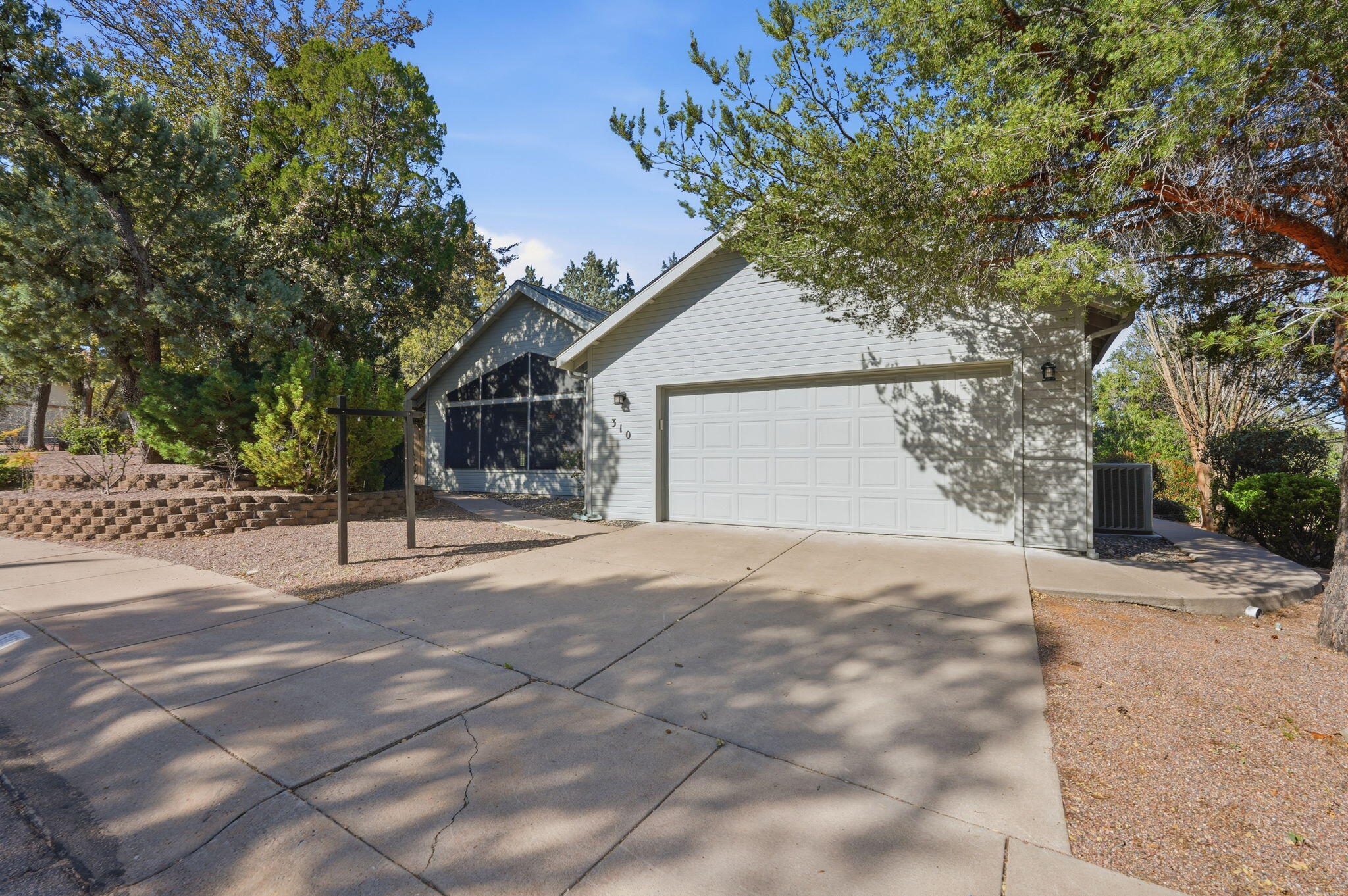 310 North Trailwood Road Payson, AZ 85541 - Photo 3 of 55 a house with trees in front of it