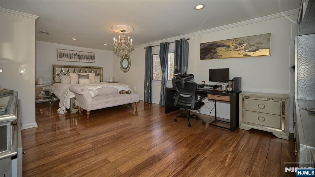 224 Pompton Road Haledon, NJ 07508 - Photo 20 of 34 a bedroom with furniture and a chandelier
