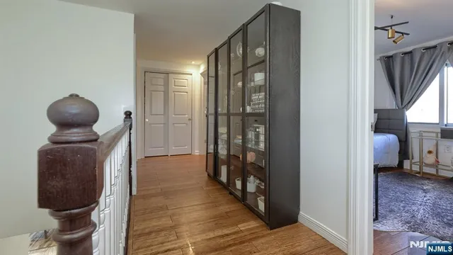 a hallway with front door wooden floor and windows