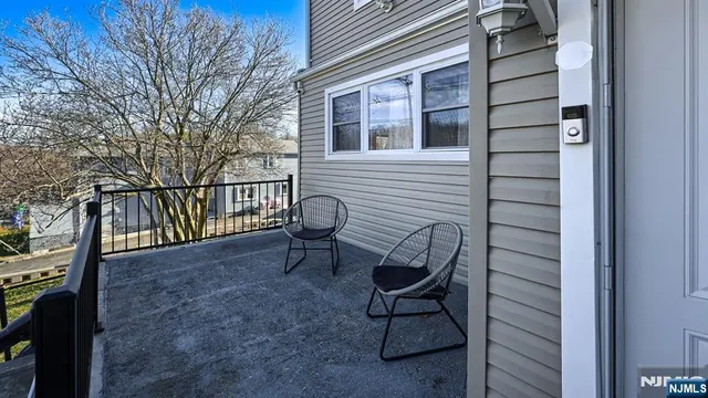 a view of backyard with deck and outdoor seating