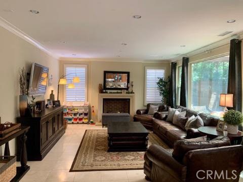 74 Nassau Irvine, CA 92620 - Photo 2 of 17 a living room with furniture large window and a fireplace
