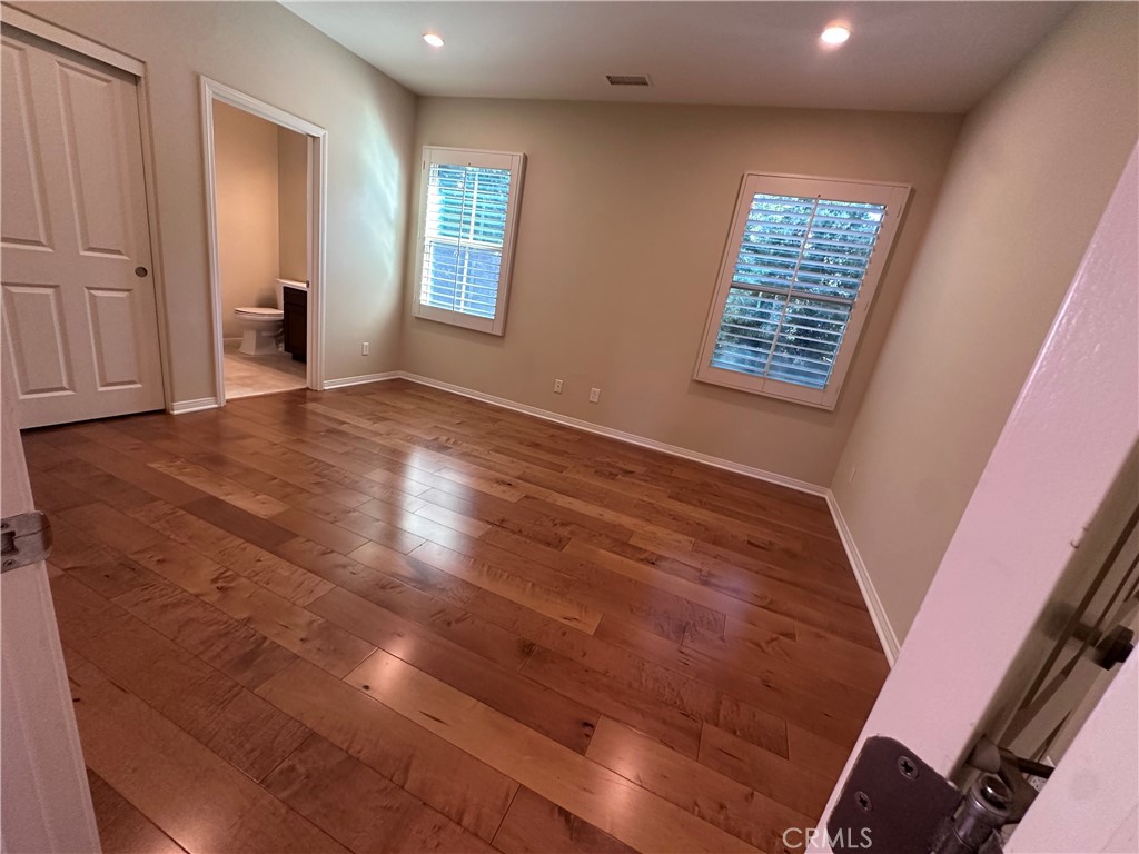 74 Nassau Irvine, CA 92620 - Photo 27 of 37 a view of an empty room with wooden floor and a window