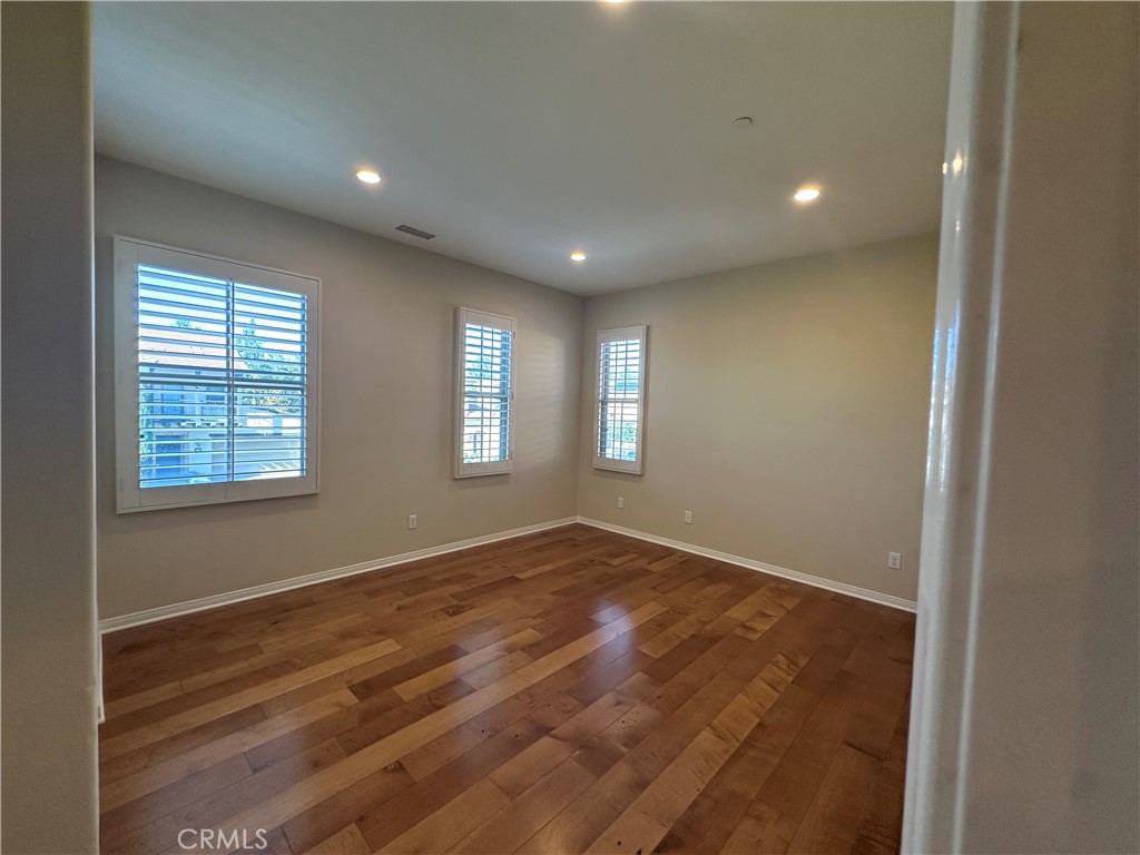 74 Nassau Irvine, CA 92620 - Photo 28 of 37 a view of empty room with wooden floor and fan