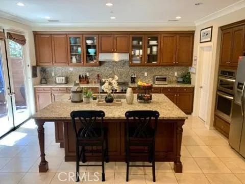 a kitchen with a sink chairs and microwave