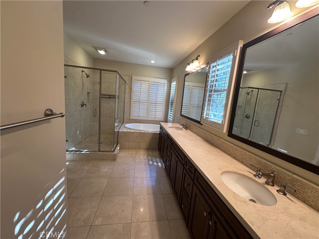 74 Nassau Irvine, CA 92620 - Photo 35 of 37 a bathroom with a double vanity sink and mirror with shower