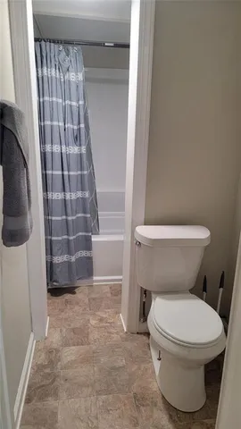 a bathroom with a toilet and a shower