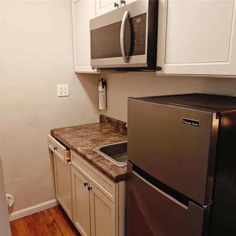 a stove top oven sitting inside of a kitchen