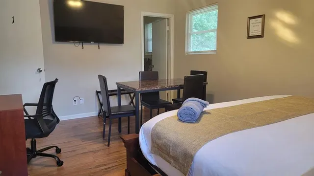 a bedroom with a bed and a flat screen tv