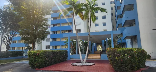 a front view of a building with a garden