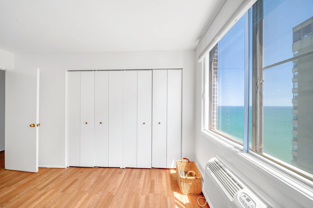 6325 North Sheridan Road, Unit 1903 Chicago, IL 60660 - Photo 12 of 20 a view of a room with wooden floor and a window