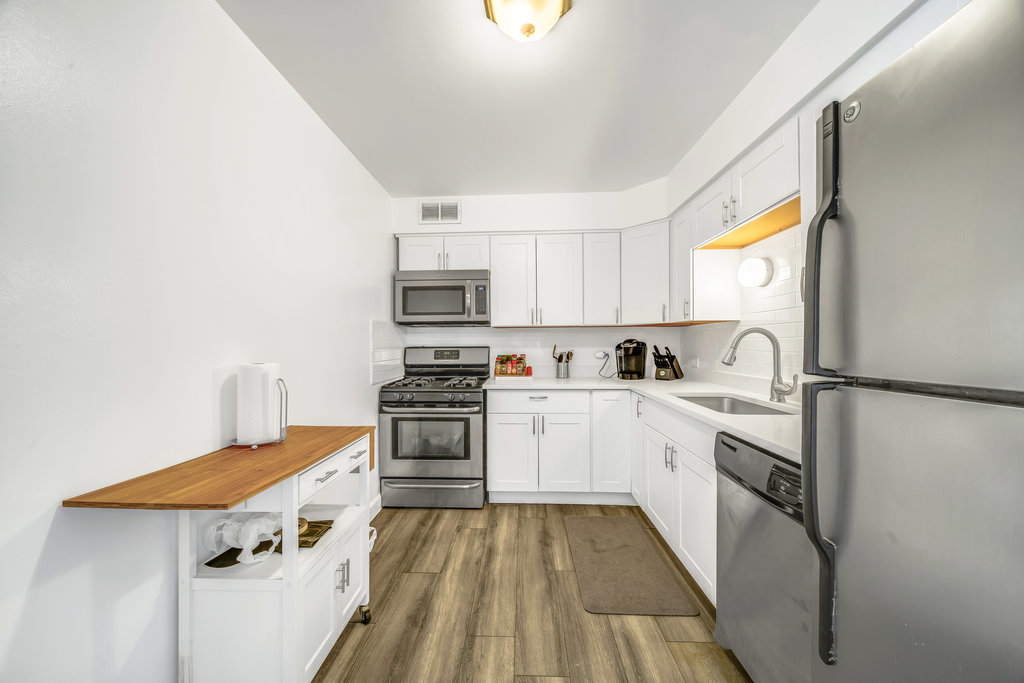 6325 North Sheridan Road, Unit 1903 Chicago, IL 60660 - Photo 5 of 20 a kitchen with stainless steel appliances a stove refrigerator sink and white cabinets