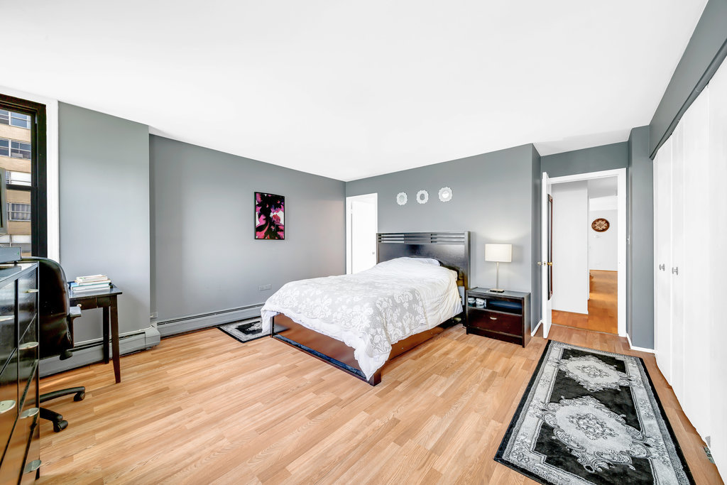 6325 North Sheridan Road, Unit 1903 Chicago, IL 60660 - Photo 9 of 20 a bedroom with a bed and wooden floor