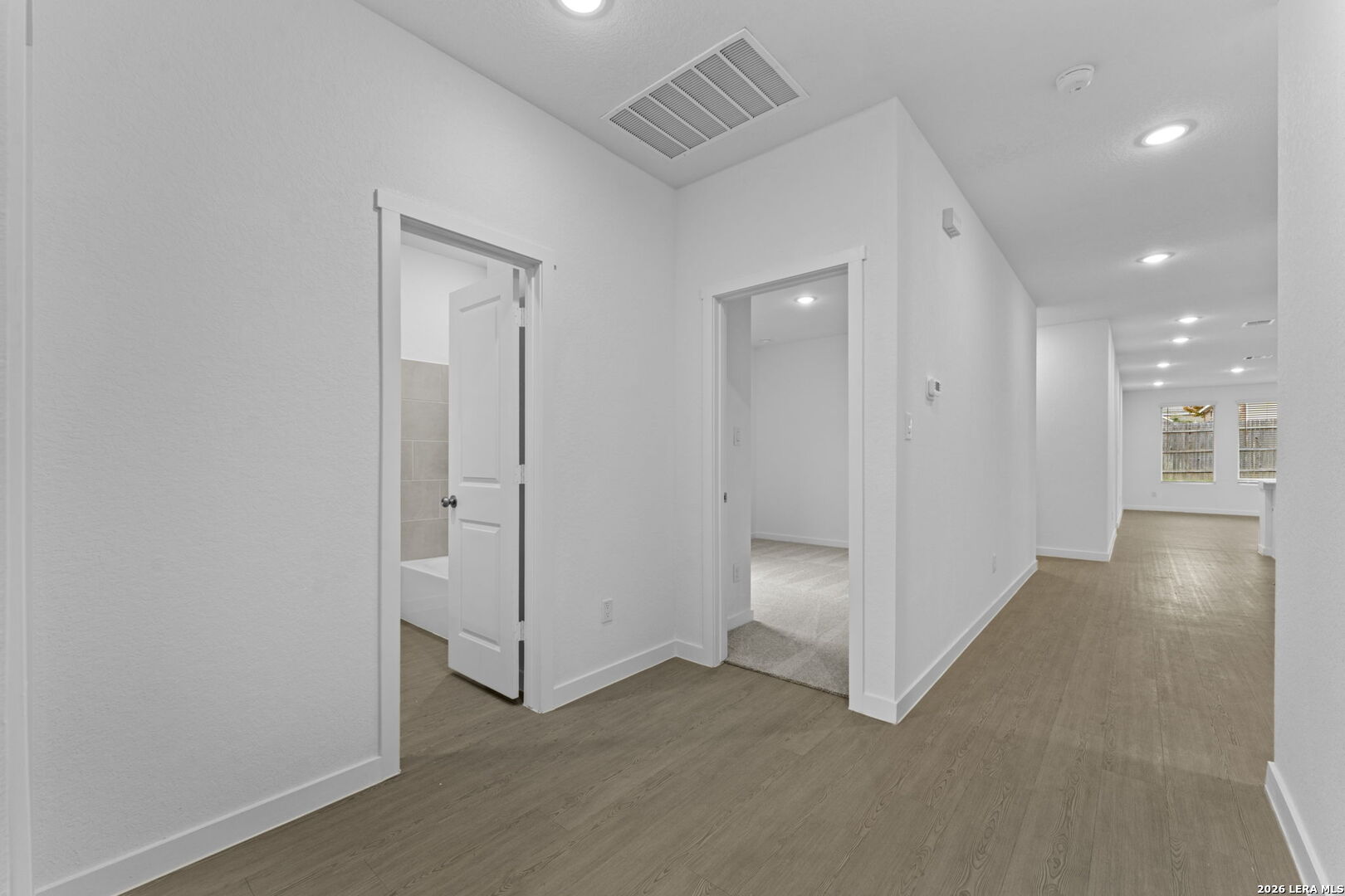 2331 Fort Davis Pass Marion, TX 78124 - Photo 2 of 28 an empty room with windows and entrance to other room