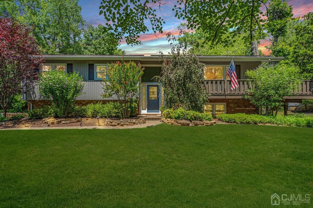 a front view of a house with plants and garden