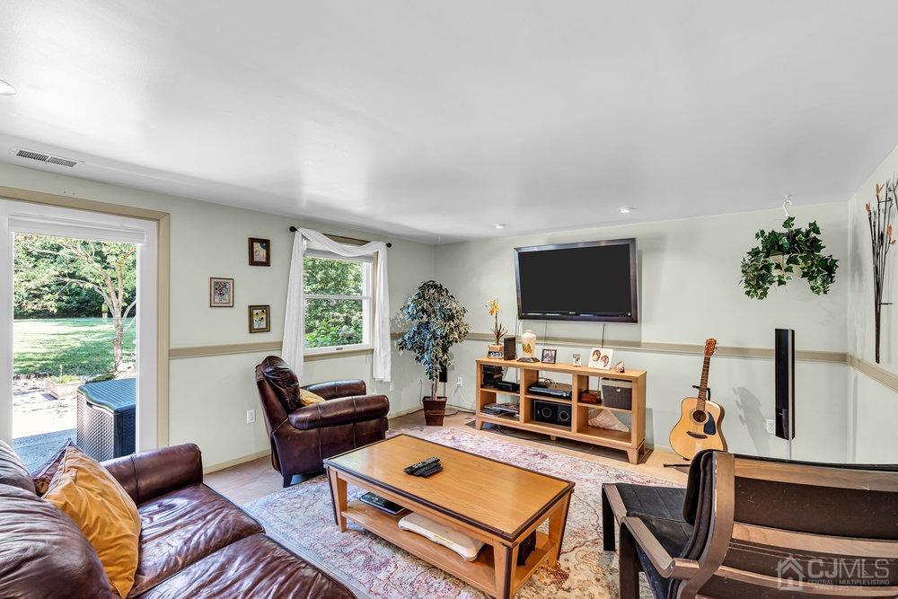 24 Chandler Road Edison, NJ 08820 - Photo 13 of 30 a living room with furniture and a flat screen tv