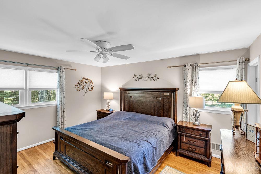 24 Chandler Road Edison, NJ 08820 - Photo 16 of 30 a bedroom with a bed and a chandelier