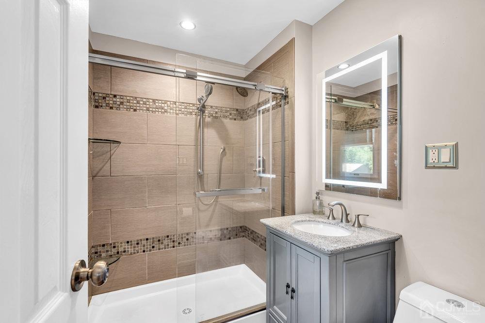 24 Chandler Road Edison, NJ 08820 - Photo 17 of 30 a bathroom with a sink and a mirror