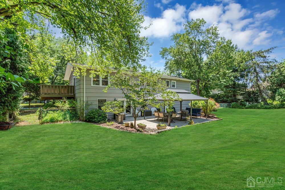 24 Chandler Road Edison, NJ 08820 - Photo 25 of 30 a view of a chair and table in backyard of the house