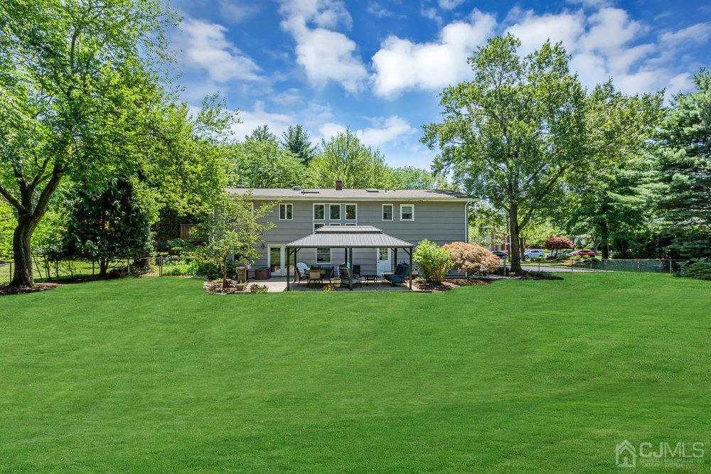 24 Chandler Road Edison, NJ 08820 - Photo 27 of 30 a view of a house with a big yard and large trees