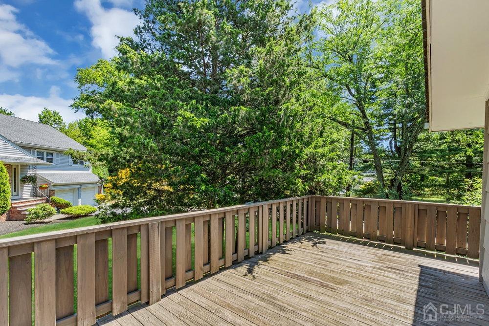 24 Chandler Road Edison, NJ 08820 - Photo 29 of 30 a wooden deck with trees in front of it