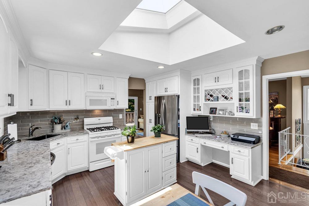 24 Chandler Road Edison, NJ 08820 - Photo 3 of 30 a kitchen with white cabinets and white appliances