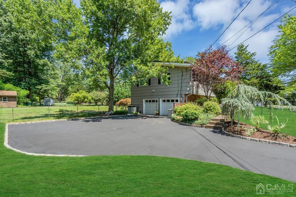 24 Chandler Road Edison, NJ 08820 - Photo 4 of 30 a view of a house with a garden and a tree