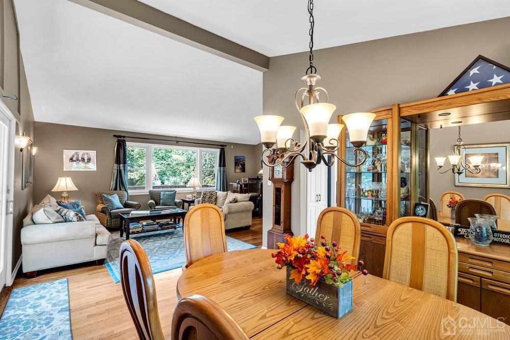 24 Chandler Road Edison, NJ 08820 - Photo 9 of 30 a living room with furniture a chandelier and a large window