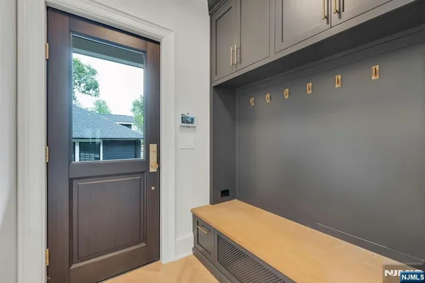 a view of a room with wooden floor and white walls