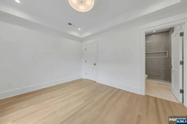 a bedroom with a bed and a potted plant
