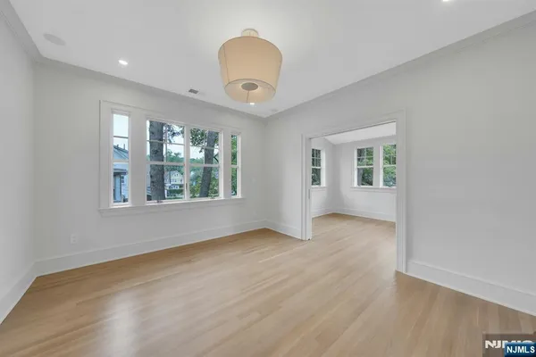 a bedroom with a large bed and a chandelier