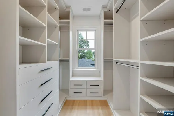a bathroom with a granite countertop double vanity sink a mirror and a bathtub