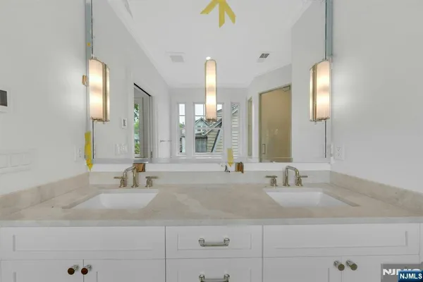 a bathroom with a sink a toilet and a mirror