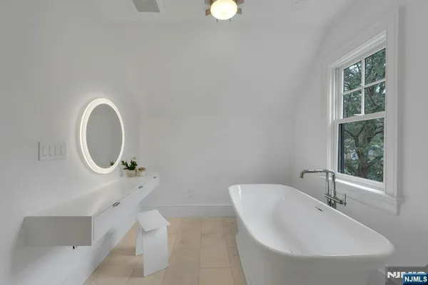 a spacious bathroom with sinks double vanity and a bathtub