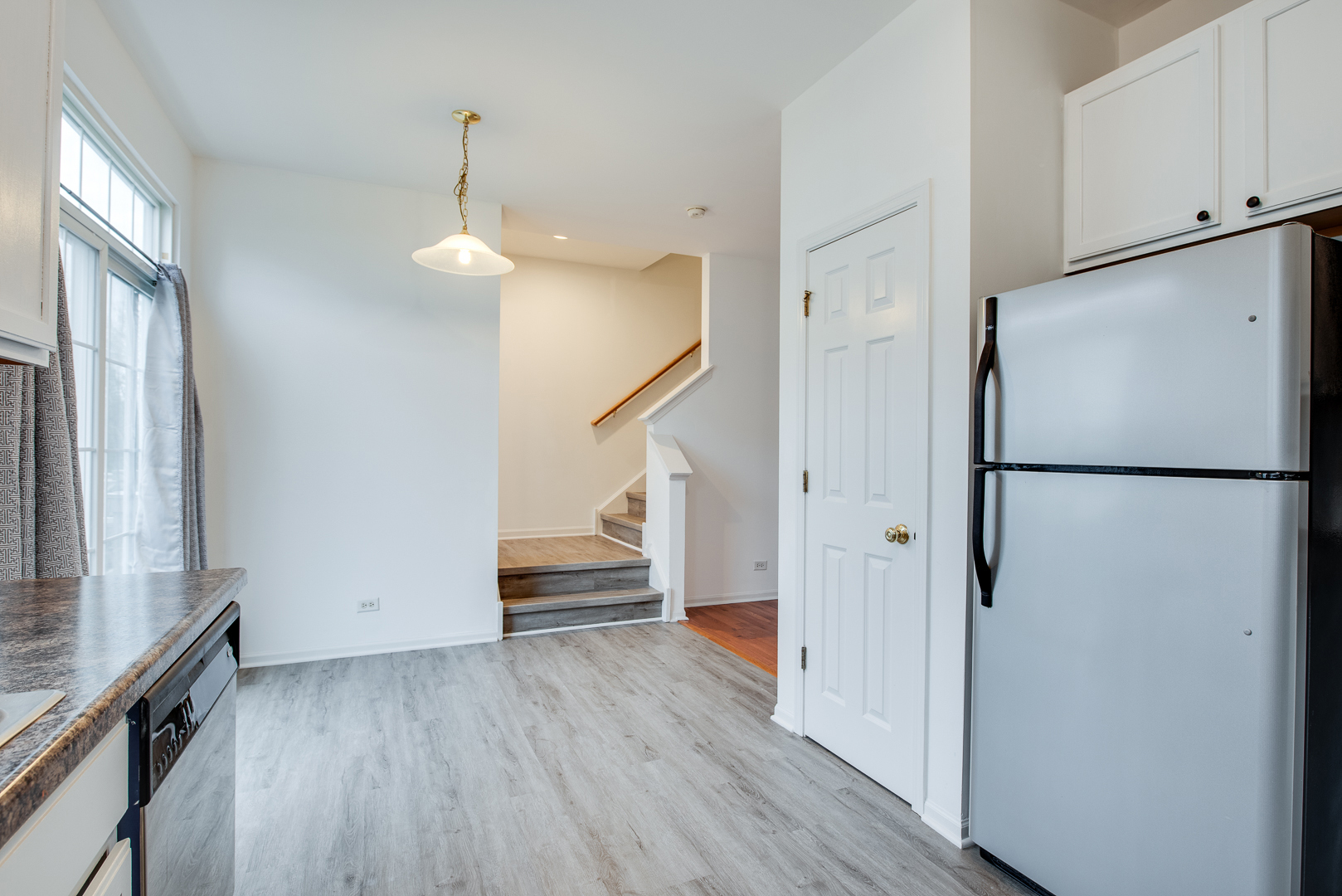 401 North Commerce Street, Unit 401 Aurora, IL 60504 - Photo 12 of 20 a view of a hallway with wooden floor and staircase