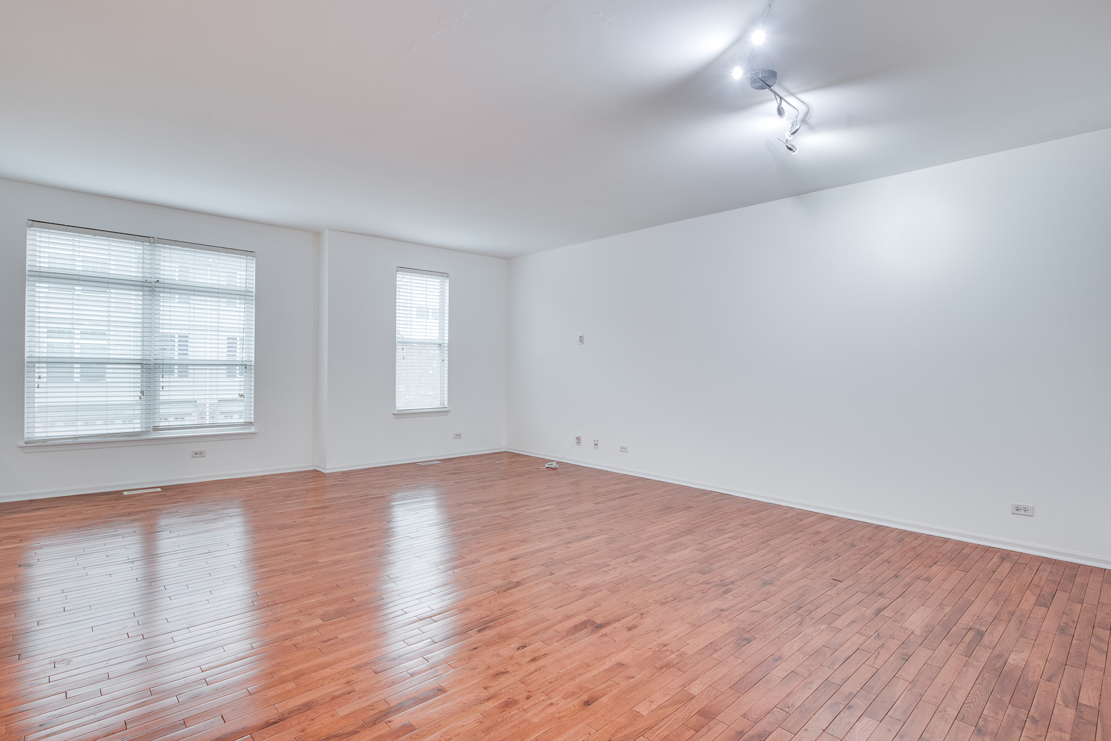 401 North Commerce Street, Unit 401 Aurora, IL 60504 - Photo 13 of 20 an empty room with wooden floor and windows