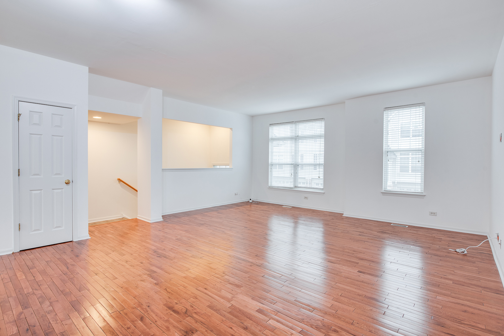 401 North Commerce Street, Unit 401 Aurora, IL 60504 - Photo 14 of 20 an empty room with wooden floor and windows
