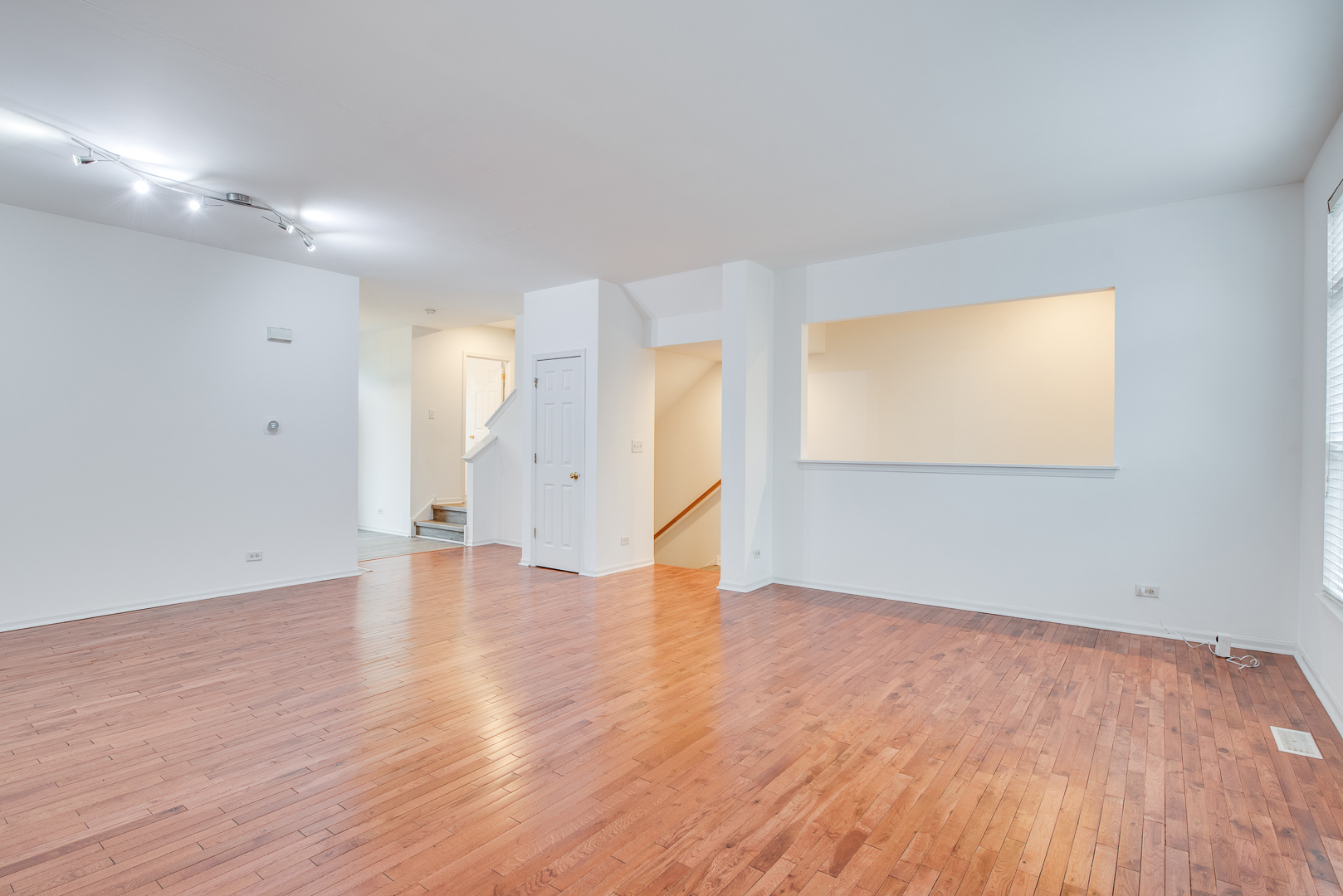 401 North Commerce Street, Unit 401 Aurora, IL 60504 - Photo 15 of 20 a view of an empty room with wooden floor and a window