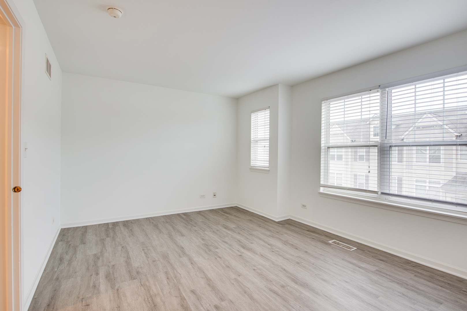 401 North Commerce Street, Unit 401 Aurora, IL 60504 - Photo 3 of 20 an empty room with wooden floor and windows