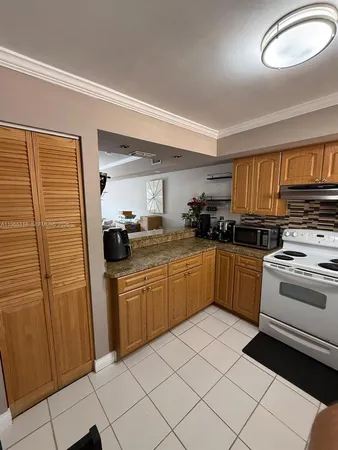 a kitchen with stainless steel appliances granite countertop a stove sink and cabinets