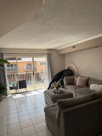 a living room with furniture and a floor to ceiling window