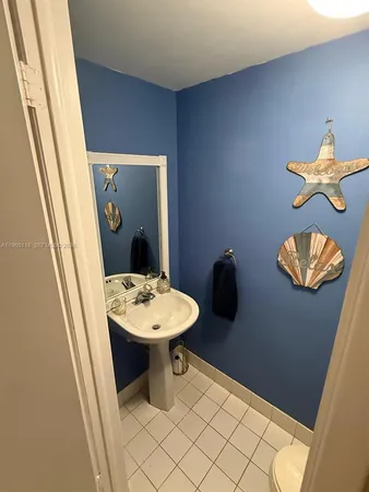 a bathroom with a sink mirror and toilet