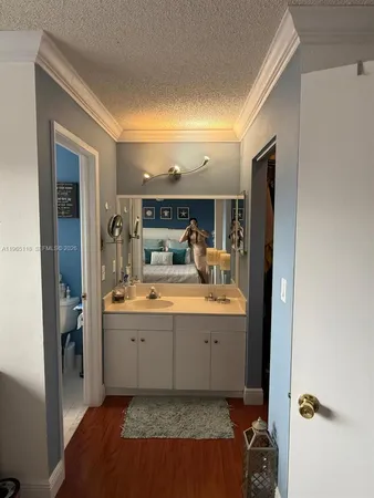 a room with sink and mirror