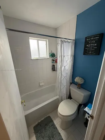 a bathroom with a toilet a sink and a shower