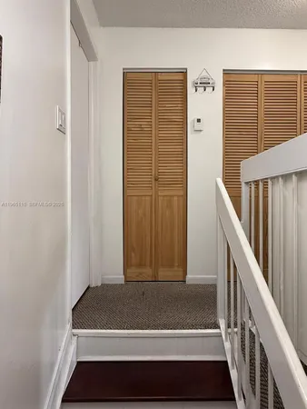 a view of front door of stairs