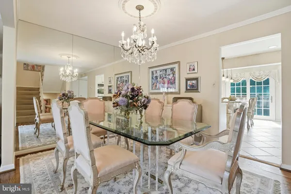 a view of a dining room with furniture and chandelier