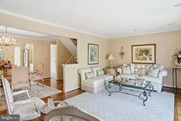 a living room with furniture a wooden floor and a table