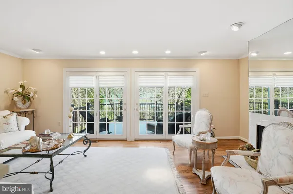 a living room with furniture and floor to ceiling windows