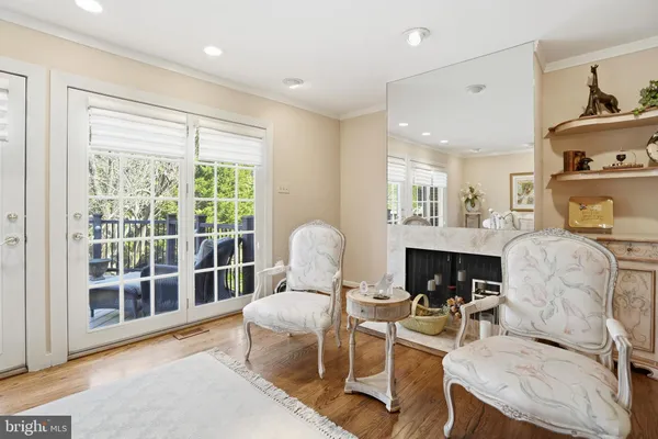 a living room with furniture a fireplace and a large window