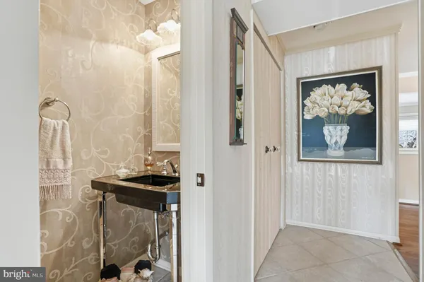 a view of a hallway with paintings on the wall