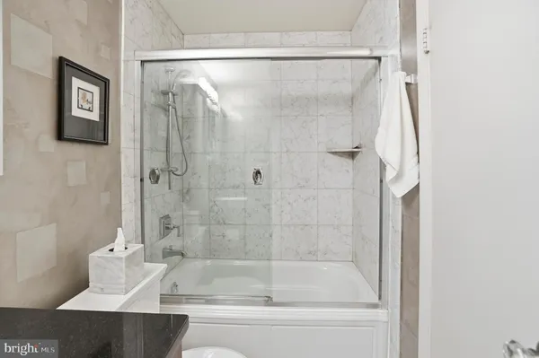 a bathroom with a bathtub and a shower